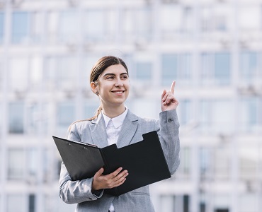 modern-businesswoman-with-clipboard-outdoors
